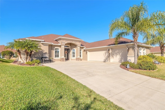 mediterranean / spanish house featuring a front lawn and a garage