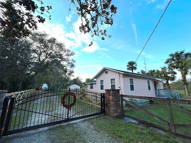 view of gate with a yard