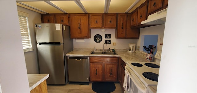 kitchen featuring sink, stainless steel appliances, and range hood