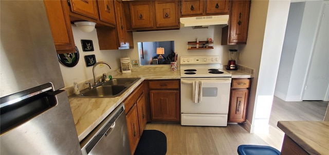 kitchen with sink, stainless steel appliances, and light hardwood / wood-style flooring