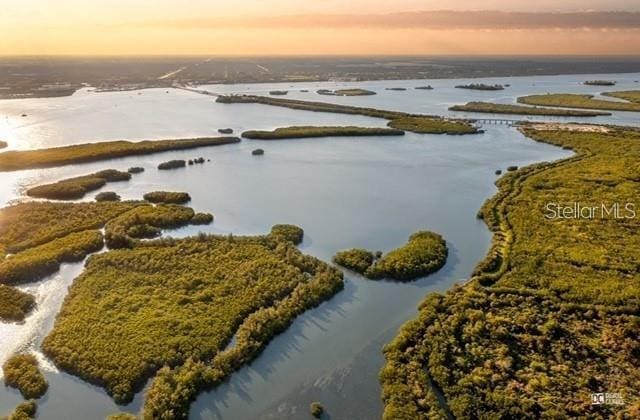 aerial view at dusk with a water view