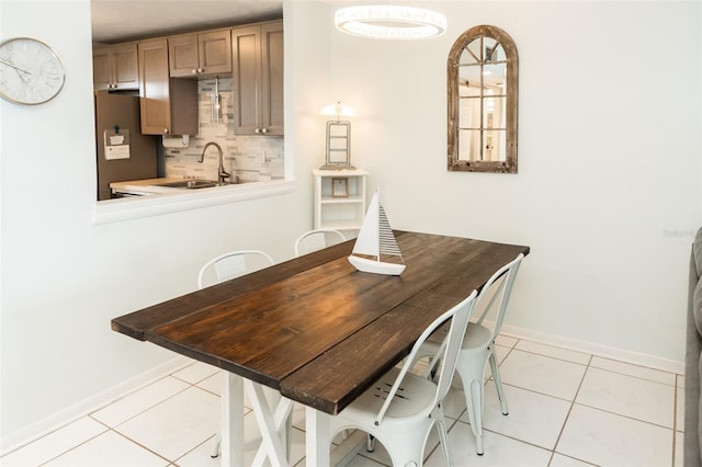 dining room featuring sink and light tile patterned floors