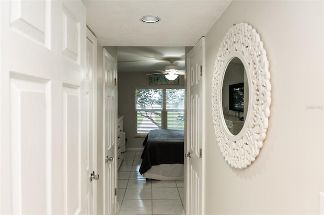 hall featuring light tile patterned flooring