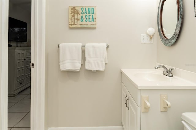 bathroom featuring tile patterned flooring, vanity, and toilet