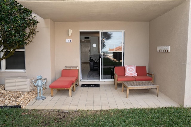 view of exterior entry featuring a patio area