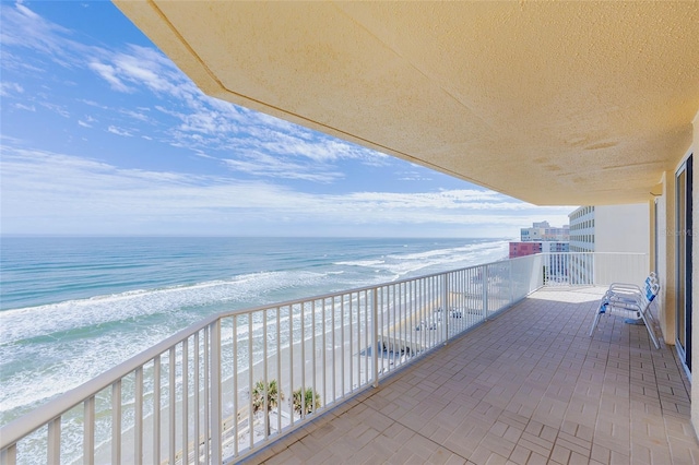 balcony with a beach view and a water view