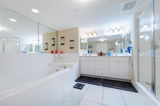 bathroom with independent shower and bath, vanity, and tile patterned floors