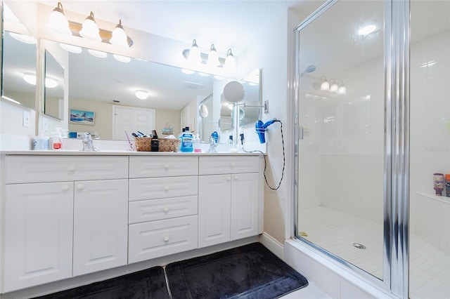 bathroom featuring vanity and a shower with shower door