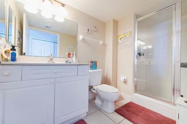 bathroom with walk in shower, vanity, tile patterned floors, and toilet