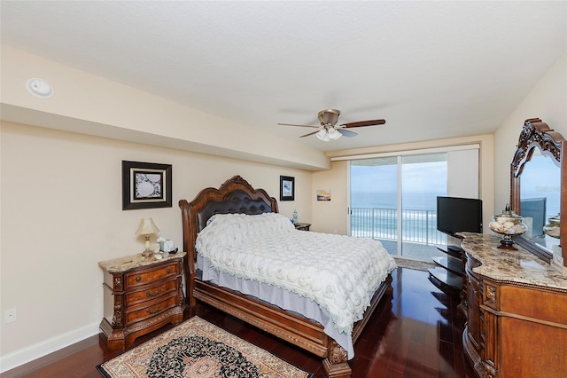 bedroom featuring access to exterior, ceiling fan, and dark wood-type flooring