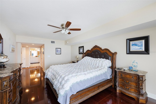 bedroom featuring ensuite bathroom, ceiling fan, and dark hardwood / wood-style floors