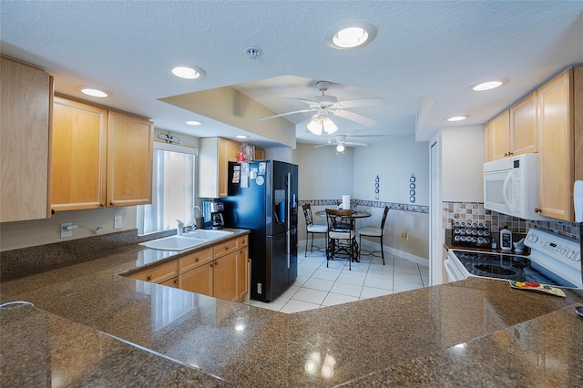 kitchen with white appliances, light brown cabinetry, light tile patterned floors, tasteful backsplash, and sink