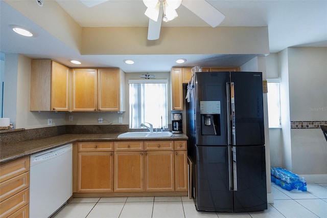 kitchen featuring black fridge, light tile patterned floors, white dishwasher, ceiling fan, and sink