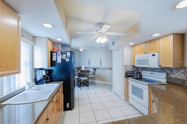 kitchen with light brown cabinets, white appliances, ceiling fan, tasteful backsplash, and light tile patterned floors