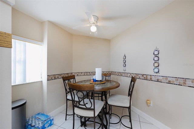 dining space featuring ceiling fan and light tile patterned floors