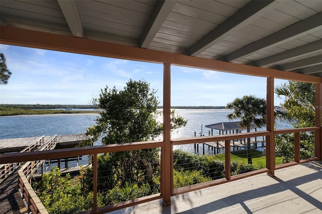 wooden terrace featuring a water view