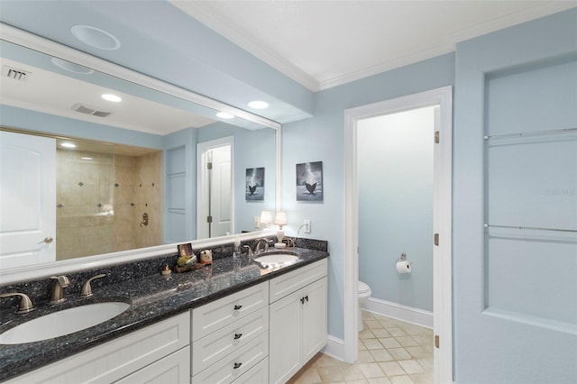 bathroom featuring a tile shower, vanity, crown molding, tile patterned flooring, and toilet