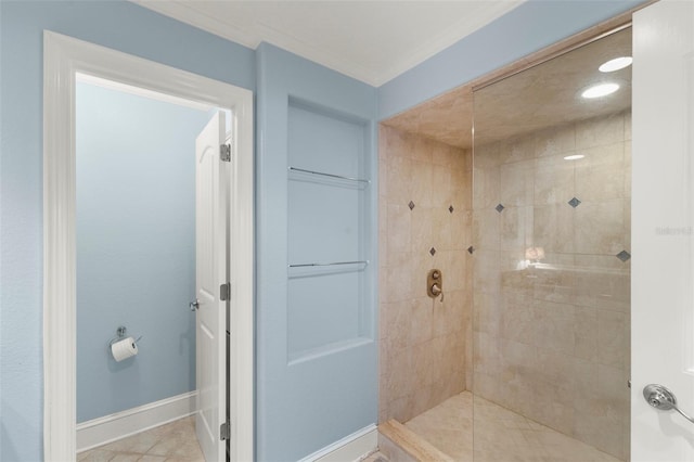 bathroom with tile patterned floors, ornamental molding, and tiled shower