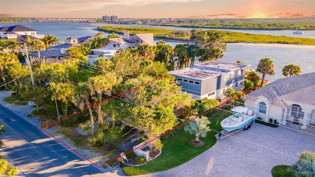 aerial view at dusk with a water view