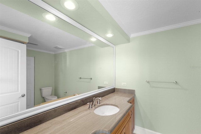 bathroom featuring baseboards, ornamental molding, toilet, and vanity