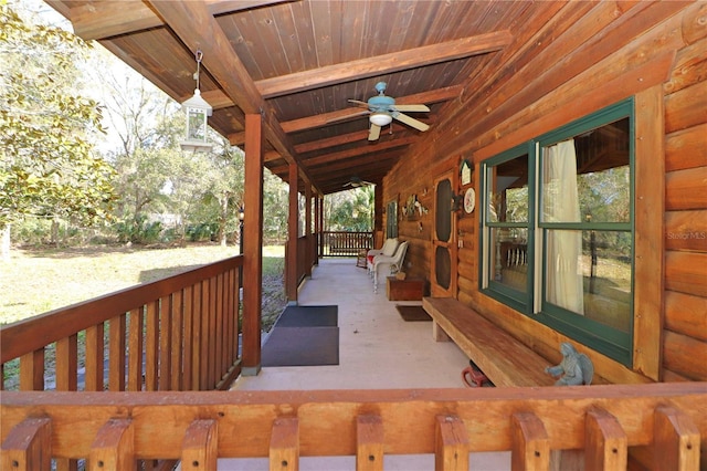 wooden terrace with covered porch and ceiling fan