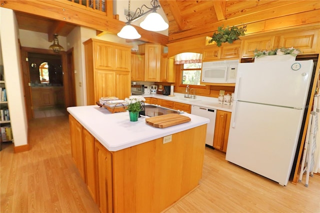 kitchen featuring light hardwood / wood-style flooring, a kitchen island, pendant lighting, and white appliances