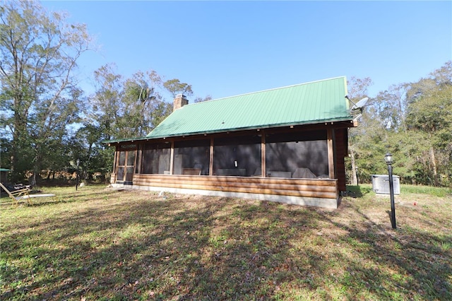 back of house featuring a sunroom and a yard