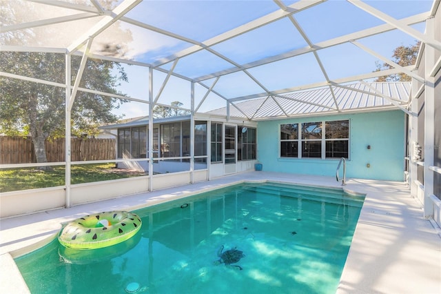 view of pool with a lanai, a fenced in pool, a patio, and fence