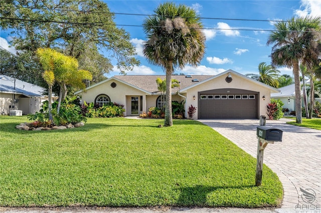 view of front of property featuring a front yard and a garage