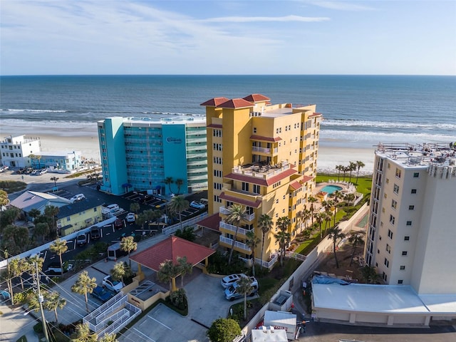 drone / aerial view featuring a water view and a view of the beach