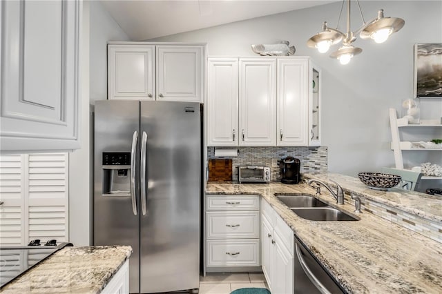 kitchen featuring appliances with stainless steel finishes, sink, decorative light fixtures, white cabinetry, and lofted ceiling