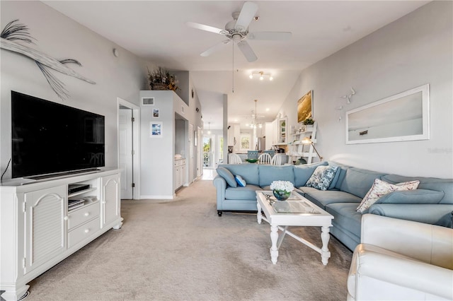 carpeted living room featuring ceiling fan and lofted ceiling