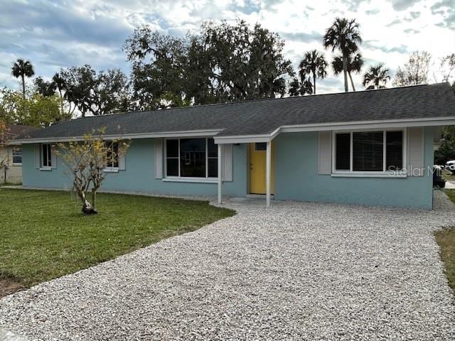 ranch-style house featuring a front lawn