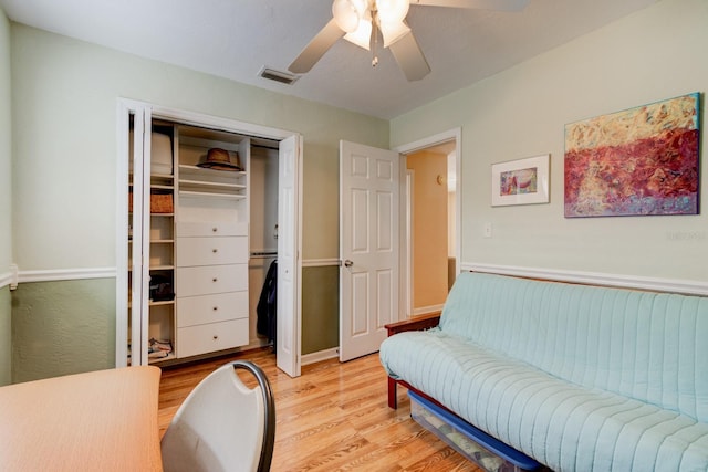 interior space featuring ceiling fan, light hardwood / wood-style floors, and a closet