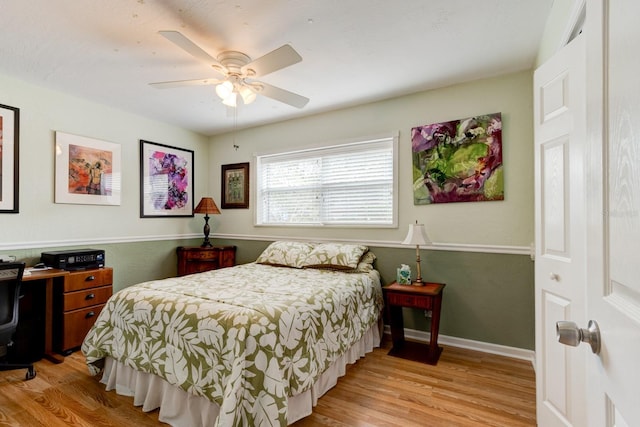 bedroom with ceiling fan and light hardwood / wood-style flooring