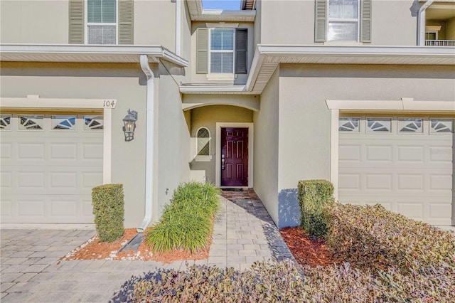 doorway to property with a garage