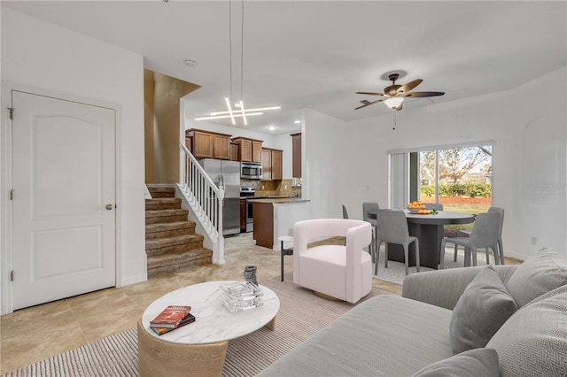 living room featuring ceiling fan and light tile patterned floors