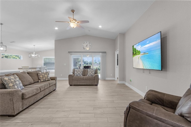 living room featuring plenty of natural light, light hardwood / wood-style floors, and ceiling fan with notable chandelier