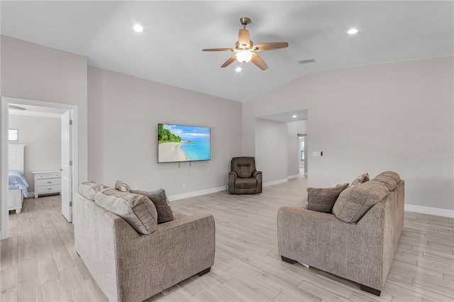 living room with light wood-type flooring, vaulted ceiling, and ceiling fan