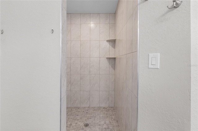 bathroom with a tile shower