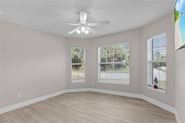 unfurnished room with ceiling fan and light hardwood / wood-style flooring