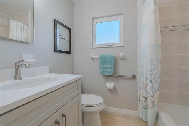 bathroom with shower / bath combo, toilet, vanity, and baseboards