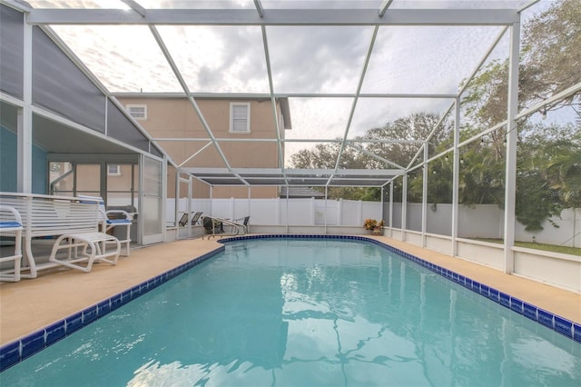 view of swimming pool with a fenced in pool, a lanai, and fence