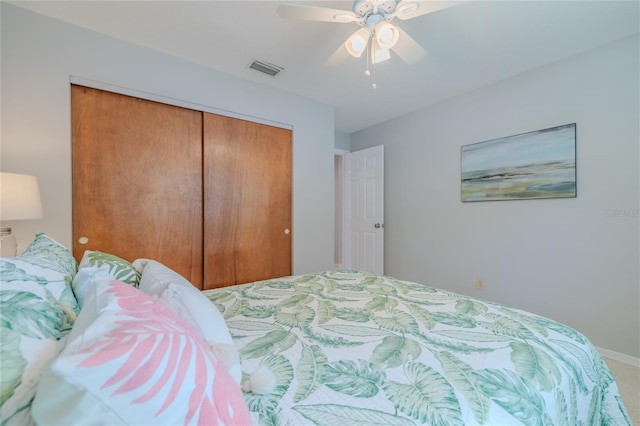 bedroom featuring ceiling fan, visible vents, and a closet