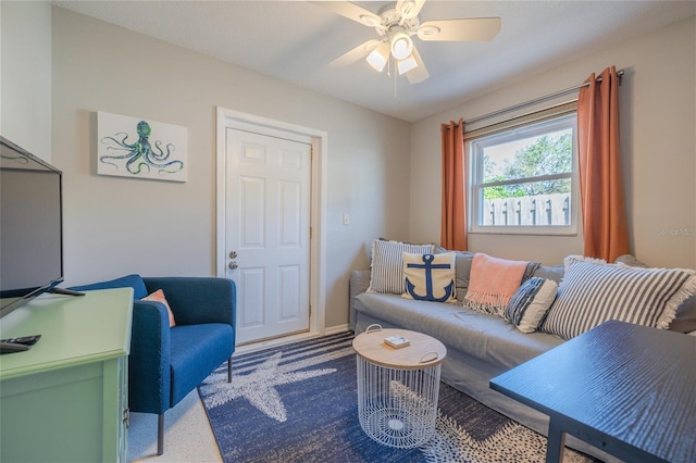 living area featuring a ceiling fan