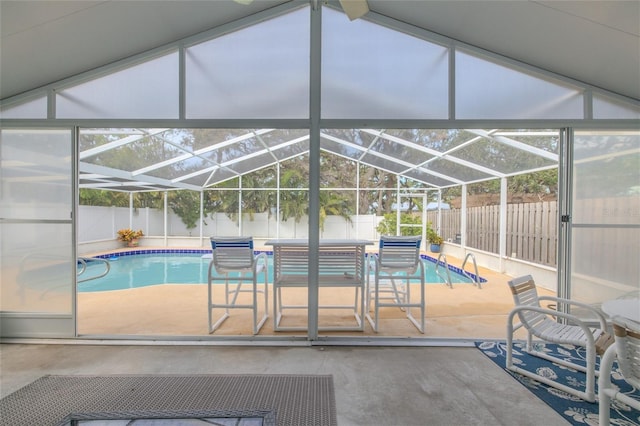 view of swimming pool with glass enclosure, a fenced backyard, a patio area, and a fenced in pool