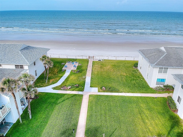 birds eye view of property with a water view and a view of the beach