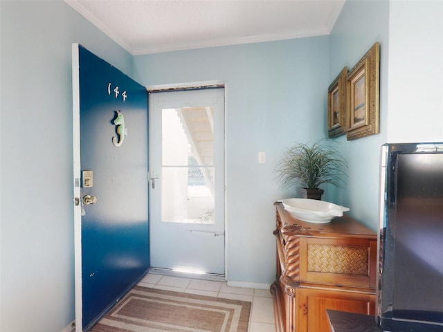 doorway to outside featuring crown molding and light tile patterned floors