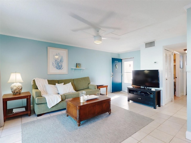 living room featuring ceiling fan, light tile patterned floors, and ornamental molding