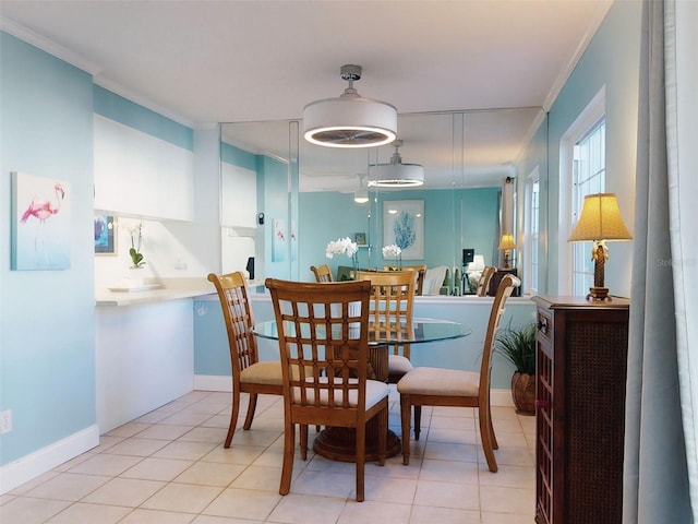 dining area with light tile patterned floors and crown molding